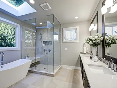 high end bathroom remodel with skylight over bathtub