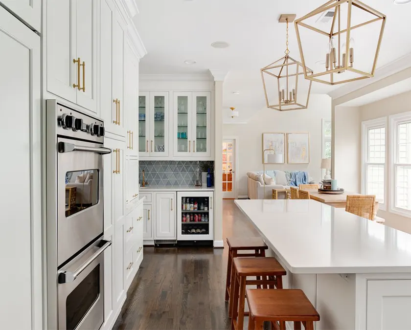 Kitchen with white cabinets with gold pulls