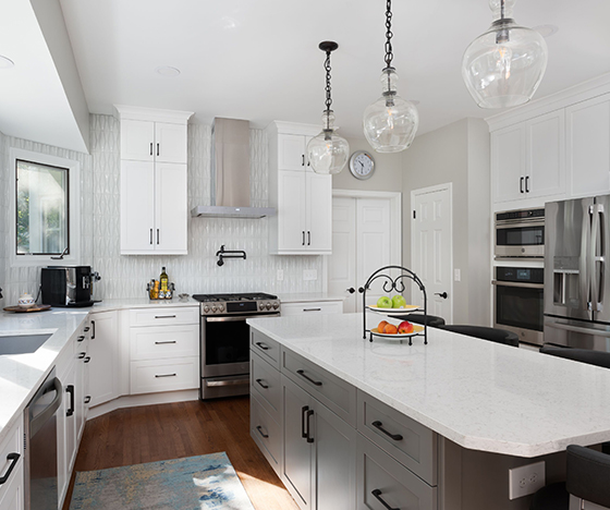 Kitchen with custom white backsplash