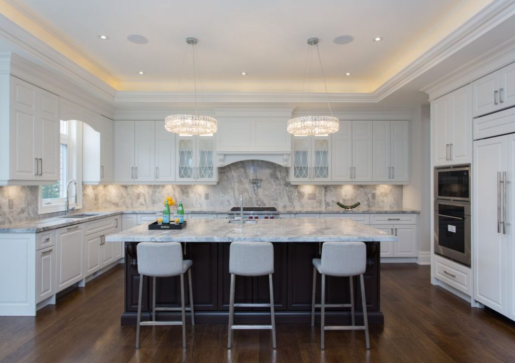 Two chandeliers over kitchen island