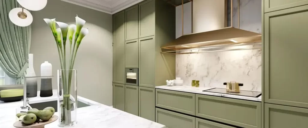 Elegant kitchen with muted olive green cabinets, white marble countertops and backsplash, and integrated modern appliances.