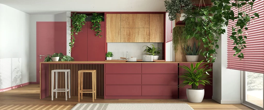 Contemporary kitchen featuring deep red lower cabinets, light wood upper cabinets, and a matching island with slatted wood detail.