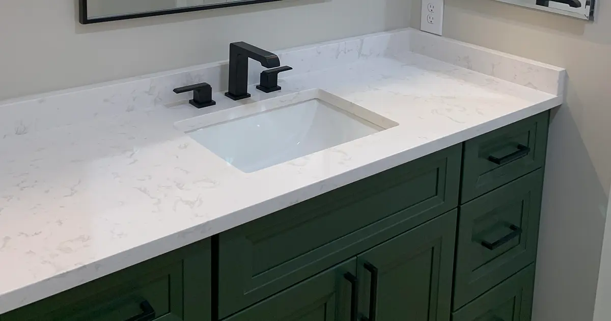 White bathroom countertop with dark green vanity
