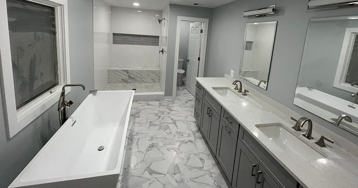 Complete bathroom remodel with walk-in shower, large double vanity, freestanding tub, and hexagon marble flooring