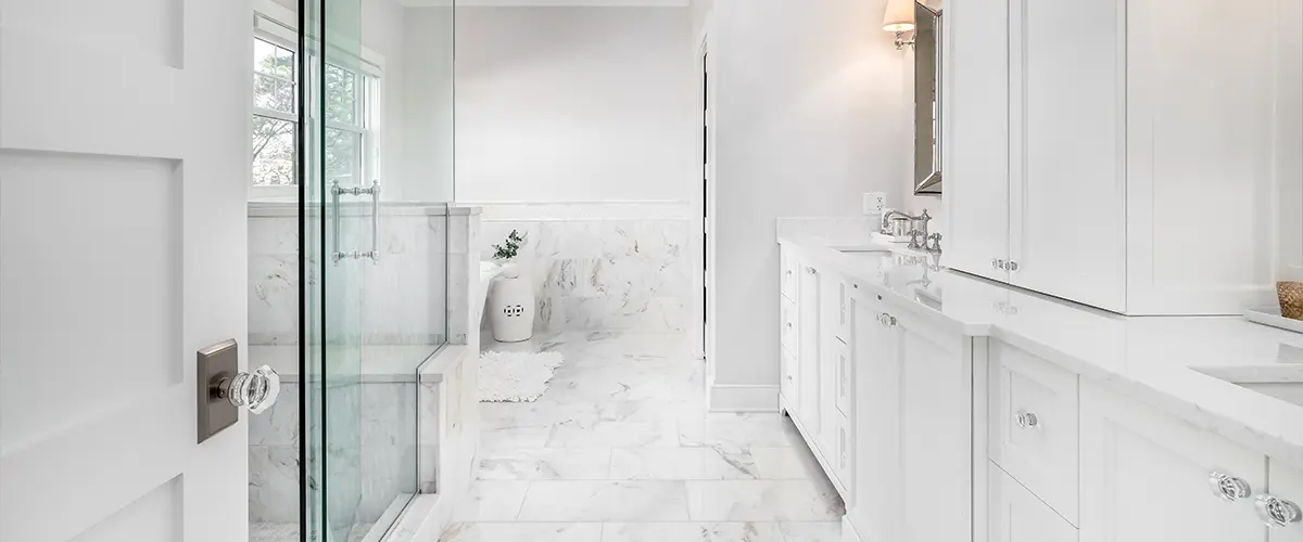 A bathroom remodeling in Chantilly with tile flooring and white cabinets