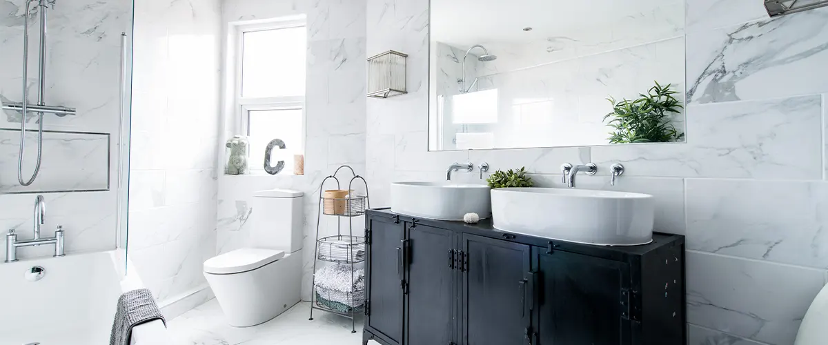 bathroom with wall tile and double sink