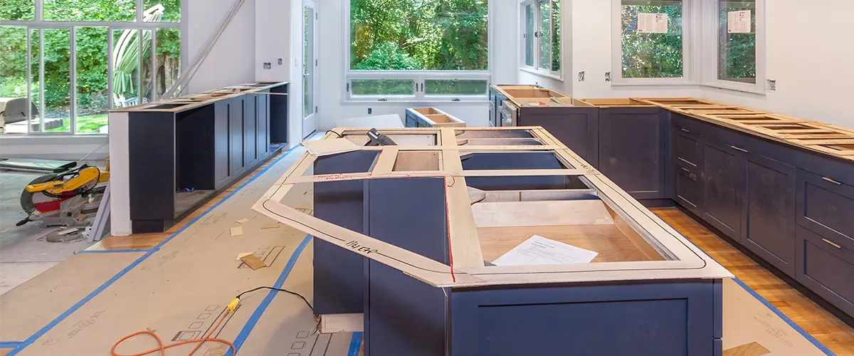 Blue kitchen cabinets being installed