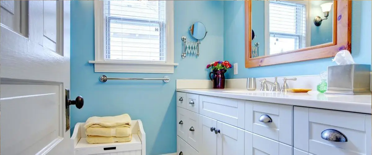 Chic Bull Run bathroom remodel with blue accents and white cabinets.
