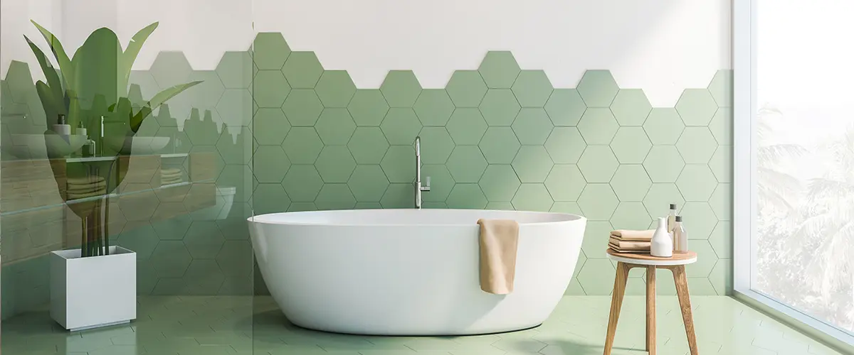 Green and white tile bathroom interior, tub