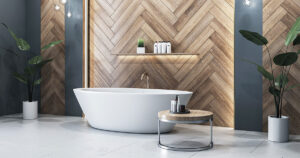 Elegant bathroom with white freestanding tub and wood panel wall.