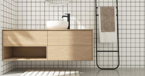 Wooden brown bathroom vanity counter, white washbasin, black faucet, mirror in sunlight on square white tile black grout