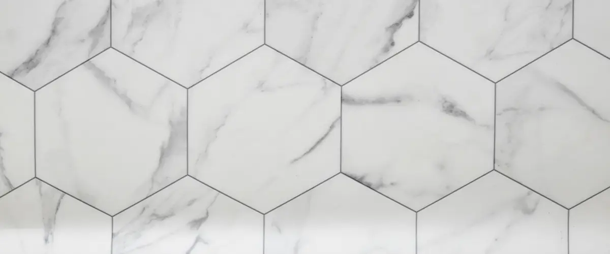 white tiles with black grout, white marble wall with hexagon tiles