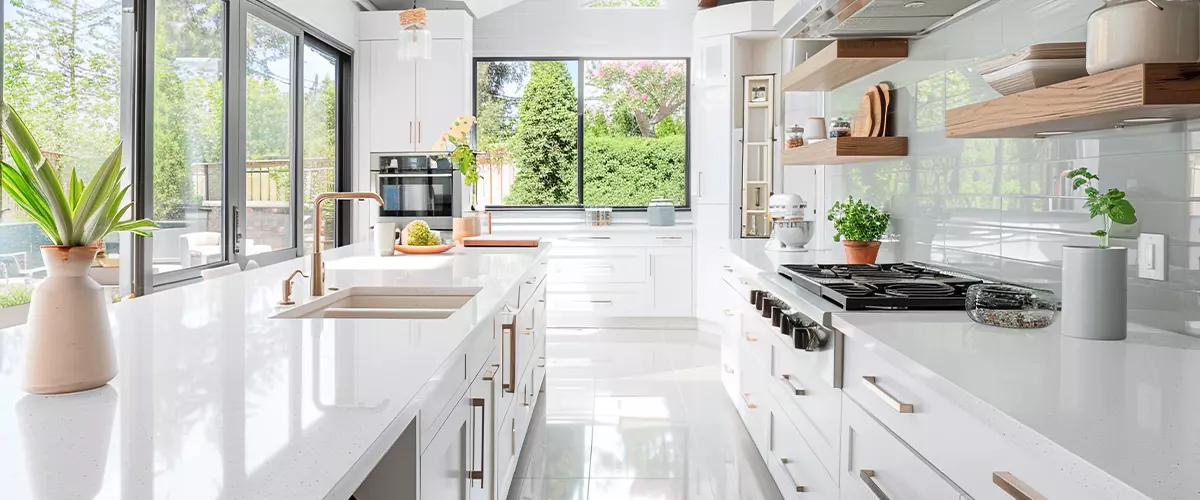 A bright, airy kitchen design that exudes contemporary elegance, featuring white quartz countertops, minimalist cabinetry, and an expansive skylight flooding the room with natural light