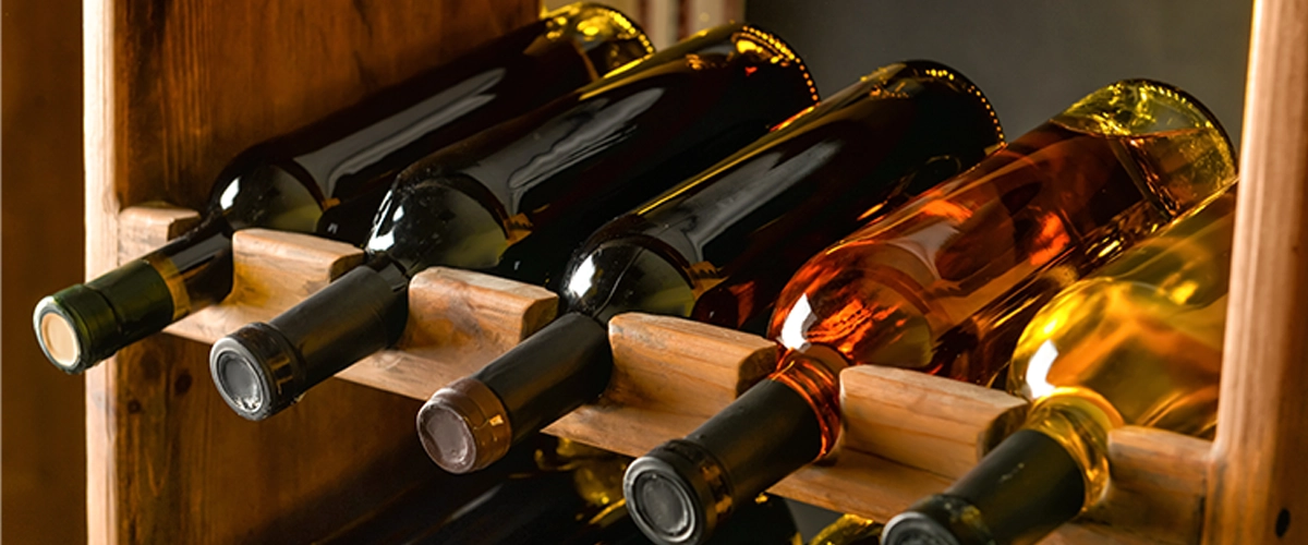 Wooden holder with bottles of wine in cellar