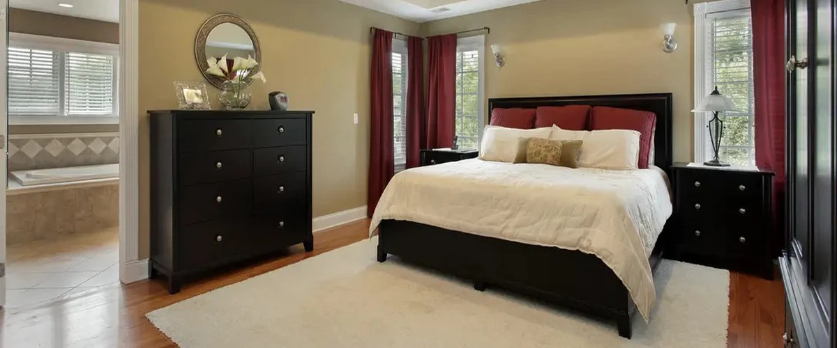 A cozy family home bedroom with neutral decor, soft lighting, and updated architectural details.